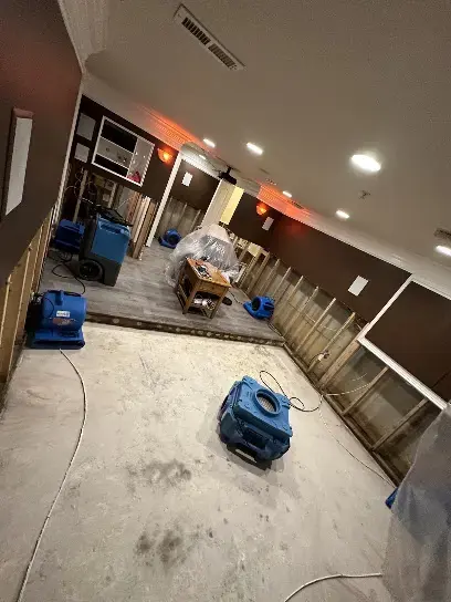 Dehumidifier drying a gutted room with the walls opened